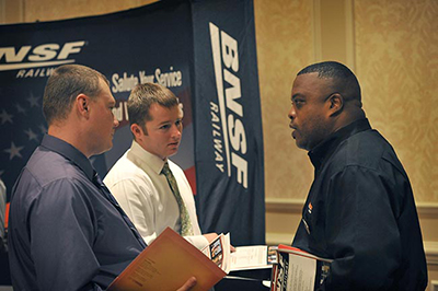 John Wesley, BNSF military recruiter, right, speaks with transitioning military personnel at the USO/Hire Heroes USA Career Day on Thursday, July 24, 2014 in Colorado Springs, Colo.
