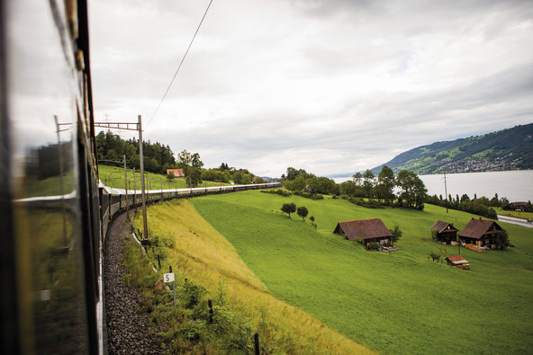 The Venice Simplon-Orient-Express moving through the Swiss countryside.