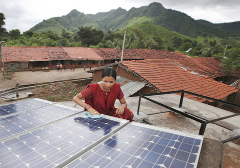 A <a href="http://opinionator.blogs.nytimes.com/2013/09/11/the-next-wireless-revolution-in-light/">solar engineer cleans a solar array</a> in a rural village of Puttur in Karnataka state in India. The solar array powers a school that now has extra classes for students at night thanks to the additional power.