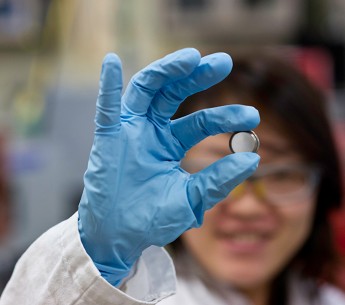 A scientist holds a lithium Ion battery made in the materials lab at the Solar Energy Research Facility at the National Renewable Energy Laboratory in Golden, CO.
