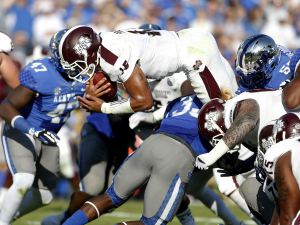 Mississippi State Bulldogs quarterback Dak Prescott dives for a touchdown against the Kentucky Wildcats in the first half at Commonwealth Stadium.