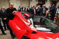 Sergio Marchionne, chief executive of Fiat Chrysler, with a Ferrari outside the New York Stock Exchange.