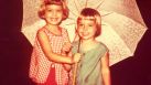 In 1968 the Semlinger sisters, Mary Ann, 5, and Caroline, 4, were captured huddled under an umbrella in the rain outside their San Antonio home.