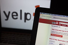 The Yelp Inc. website and logo are displayed on laptop computers in this arranged photograph in Washington, D.C., U.S., on Friday, April 25, 2014. Yelp Inc. is expected to release earnings figures on April 30. Photographer: Andrew Harrer/Bloomberg
