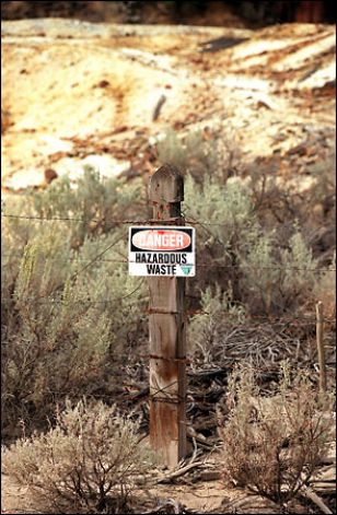 A notice warns of a waste pile from an old mine in Washington near the Canadian border. Hundreds of thousands of such abandoned mines -- no one knows how many -- lace federal lands in the West. One watchdog group puts the cleanup costs at $32 billion to $72 billion Photo: Gilbert W. Arias/Seattle Post-Intelligencer