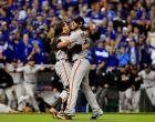 Buster Posey hugs Madison Bumgarner, who only allows two hits while throwing five scoreless innings in relief during Game 7 victory.
