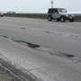 Potholes on Chicago's Lake Shore Drive, one of which is about half-a-car-length long and at least a foot deep. The city of Chicago says it has filled an estimated 240,000 potholes this winter, 100,000 more than last winter, at a cost of more than $2.8 million.