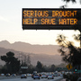 A sign over a highway in Glendale, Calif., warned motorists in February to save water in response to the state's severe drought. But a study released earlier this week showed residents in the southern coastal part of the state used more water this spring than they did last year.