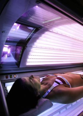 A woman lies in a tanning booth in Anchorage, Alaska on Dec 15, 2005.