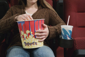 Girl in Movie Theater Eating Popcorn