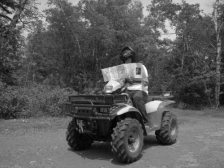 An ATV rider reads a Motor Vehicle Use Map
