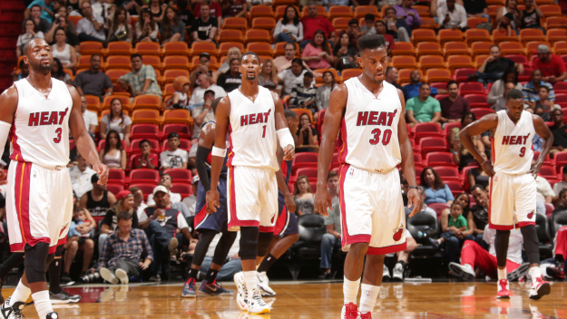 Dwyane Wade #3, Chris Bosh #1, Norris Cole #30 and Luol Deng #9 of the Miami Heat prepare for a play against the Atlanta Hawks during the game on October 14, 2014 at AmericaAirlines Arena in Miami, Florida. (Photo by Issac Baldizon/NBAE via Getty Images)