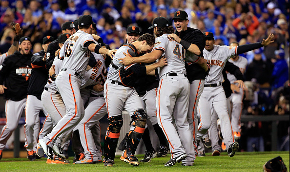 Buster Posey #28 and Madison Bumgarner #40 of the San Francisco Giants celebrate after defeating the Kansas City Royals to win Game Seven of the 2014 World Series by a score of 3-2 at Kauffman Stadium on October 29, 2014 in Kansas City, Missouri.  (Photo by Jamie Squire/Getty Images)
