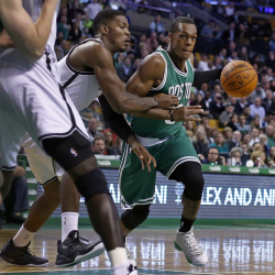 Celtics guard Rajon Rondo dribbles against Brooklyn Nets guard Joe Johnson in the first quarter of Wednesday night’s season-opening game in Boston.