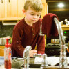 Christine Pepper's sons watch as dirty water drips from the faucet.  photo: jbpribanic