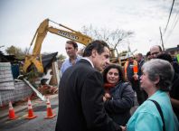 NEW YORK, NY - OCTOBER 29:  New York Governor Andrew Cuomo (C) meets with citizens after a press conference about New York state's program to buy back homes destroyed by Hurricane Sandy and allow mother nature to reclaim the land, two years after Superstorm Sandy damaged the area, on October 29, 2014 in the Oakwood Beach neighborhood of the Staten Island Borough of New York City. Huricane Sandy was recorded as the deadliest and most destructive hurricane of the 2012 Atlantic hurricane season. It caused over $68 billion in damages, and hundreds of people were killed along the path of the storm in seven countries. Today marks the two-year anniversary of its storm surge hitting New York City and the surrounding area which flooded streets, tunnels and subway lines and cut power in and around the city.  (Photo by Andrew Burton/Getty Images) ORG XMIT: 520856669