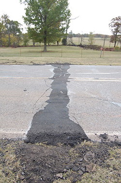 A 2011 magnitude 5.7 quake near Prague, Okla., apparently triggered by wastewater injection, buckled U.S. Highway 62. (John Leeman)