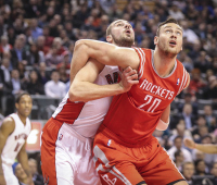 Toronto Raptors centre Jonas Valanciunas (17) gets a piggy back ride from Houston Rockets forward Donatas Motiejunas (20) who was trying to box him out at the line