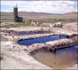 photo of several oil pits and a tank battery