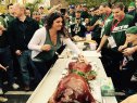 Jets fans slap the pig at WFAN's pregame party at Redd's Restaurant & Bar on October 26, 2014. (credit: John D’Alessandro/WFAN)