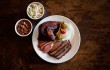 Chicken, sausage, and sliced brisket make a fine plate at the Back Forty Smokehouse. Adrien P. Maroney