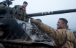 Brad Pitt (foreground) instructs Logan Lerman about operating the tank called Fury.