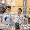 Two Chinese students work in University of Wyoming's Peabody lab.