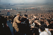 Adolf Hitler greets the cheering throng at a rally in 1937.
