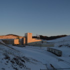 The processing plant and rail loading facility visible from inside the mine gates is tucked into a hill, hiding most of the building from the highway and subdivision to the north. The company has 1,039 acres permitted for mining and has taken steps to reduce impacts on neighbors. Alison Dirr/Wisconsin Center for Investigative Journalism