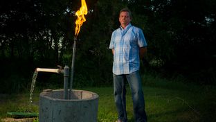 Steve Lipsky shows the methane contamination of his well by igniting the gas with a lighter outside his family's home in Parker County near Weatherford, Texas on June 17, 2014.