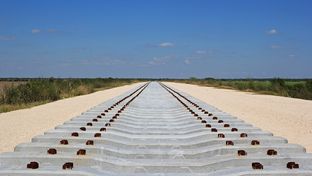 Concrete railroad ties are staged for the construction of the new Brownsville rail bridge.