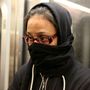 A woman on the L train in New York City last week covers her face, fearful because a doctor with Ebola rode the train days earlier. Epidemiologists say people on the subway were not at risk.