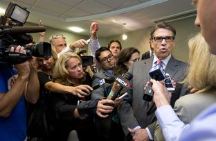New England journalists surround Gov. Rick Perry after Friday's Portsmouth business luncheon.