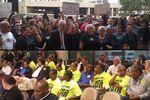 Above: Austin City Councilman Chris Riley joins supporters of legalizing vehicle-for-hire apps Uber and Lyft at a rally Thursday outside of a city council meeting. Below: Supporters of traditional taxi companies sit at the same city council meeting as the council considers an ordinance for vehicle-for-hire apps.