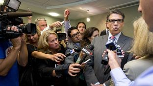 New England journalists surround Gov. Rick Perry after Friday's Portsmouth business luncheon.