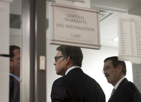 Texas Gov. Rick Perry, middle, is booked at the Blackwell-Thurman Criminal Justice Center in Austin, Texas, for two felony indictments of abuse of power on Tuesday, Aug. 19, 2014, in Austin, Texas. (AP Photo/Austin American-Statesman, Jay Janner) Photo: Jay Janner, Associated Press