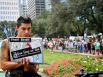 Derick Broze uses his computer's web cam to record video as he and other protestors with the Occupy Houston movement, an outgrowth of the Occupy Wall Street protests in New York, gather at City Hall in downtown Houston to denounce what they describe as social and economic equality and corporate greed, Thursday, Oct. 6, 2011, in Houston.