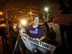 Carl Gibson, center, and other participants in the Occupy Houston movement march at Tranquillity Park after police officers cleared the park after sunset Monday on Mayor Annise Parker's orders.