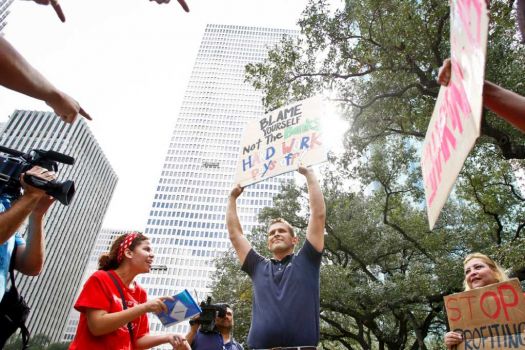 Justin Conry (second from right) an anti-protestor is confronted by protestors with the Occupy Houston movement, an outgrowth of the Occupy Wall Street protests in New York, gather at City Hall in downtown Houston to denounce what they describe as social and economic equality and corporate greed, Thursday, Oct. 6, 2011, in Houston. Photo: Michael Paulsen, Houston Chronicle / © 2011 Houston Chronicle