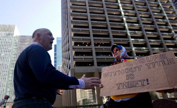 Marty Power,left, argues with Occupy Houston protestor Benjamin Franklin, right, outside of Wells Fargo Plaza Friday, Nov. 4, 2011, in Houston. Protestors made a Divestment March where they protested outside four nearby banking institutions in downtown Houston - Bank of America, JP Morgan Chase, Wells Fargo and Amegy. (Cody Duty / Houston Chronicle) Photo: Cody Duty / © 2011 Houston Chronicle