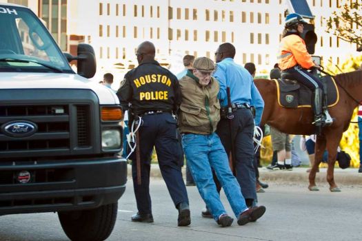 ERIC KAYNE : FOR THE CHRONICLE
HOUSTON: A member of Occupy Houston is arrested after sitting in the middle of Travis Street to block the North Freeway on-ramp after a march through downtown Thursday. Police said about a dozen of the 200-300 protesters were arrested. See story, more photos on chron.com Photo: Eric Kayne / © 2011 Eric Kayne