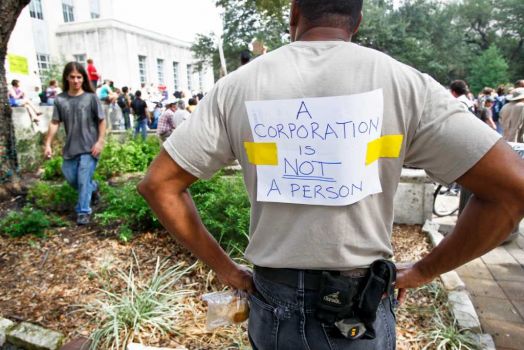 Yancy Cooper wears a sign as he and other protestors with the Occupy Houston movement, an outgrowth of the Occupy Wall Street protests in New York, gather at City Hall in downtown Houston to denounce what they describe as social and economic equality and corporate greed, Thursday, Oct. 6, 2011, in Houston. Photo: Michael Paulsen, Houston Chronicle / © 2011 Houston Chronicle