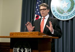 Gov. Rick Perry speaks to reporters on Aug. 16, the day after a grand jury indicted him on two felony counts related to his veto of public integrity unit funding.