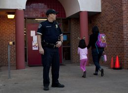 Austin Police Officer Cory Ehrler monitors the entrance to Ridgetop Elementary School after classes start on the Monday following the Sandy Hook Elementary School shooting. As the 83rd legislative session approaches, Texas lawmakers are considering making firearms more available to teachers and other school personnel.