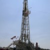 A Chesapeake Energy Corp. worker stands beside a Chesapeake oil drilling rig on the Eagle Ford shale near Crystal City, Texas, June 6, 2011.