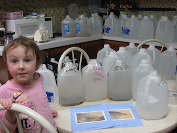 kim-mcevoys-daughter-surrounded-by-water-jugs-february-4-2012