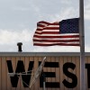 A flag is flown at half staff in West, Texas, near the scene of the fertilizer plant that exploded Wednesday night in in the town of 2,8000 on Thursday, April 18, 2013.