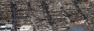 People gather around the remains of burned homes after Superstorm Sandy on October 31, 2012 in the Breezy Point neighborhood of the Queens borough of New York City.