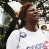 A woman protests against the proposed tax exemptions for Valero Energy Corporation