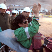Miner Claudio Yanez applauds as he is carried away on a stretcher after being rescued from the collapsed San Jose mine where he had been trapped with 32 other miners for over two months in 2010 near Copiapo, Chile.